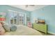 Bright bedroom with ample natural light, a dresser with TV, and coastal-themed decor at 388 Aruba Cir # 201, Bradenton, FL 34209
