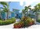 Inviting community clubhouse, surrounded by lush tropical landscaping and swaying palm trees at 388 Aruba Cir # 201, Bradenton, FL 34209