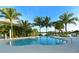 Enjoy the community pool with plenty of room for lounge chairs and mature palm trees at 388 Aruba Cir # 201, Bradenton, FL 34209