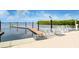 Dock with ramp leading to the water, featuring solar lights and safety lines, surrounded by serene water and greenery at 388 Aruba Cir # 201, Bradenton, FL 34209