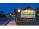 The Mangrove Walk entrance sign is warmly lit at night, inviting residents to explore the neighborhood at 388 Aruba Cir # 201, Bradenton, FL 34209