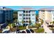 Beautiful coastal condo building featuring tropical landscaping, covered parking, and a water view at 388 Aruba Cir # 201, Bradenton, FL 34209