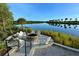 A lakeside fire pit with Adirondack chairs provides a cozy place to relax and enjoy the views at 388 Aruba Cir # 201, Bradenton, FL 34209