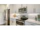 Well-equipped kitchen showcasing stainless steel appliances, ample counter space, and modern white cabinetry at 388 Aruba Cir # 201, Bradenton, FL 34209