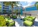 Relaxing outdoor lounge area features comfortable seating, lush landscaping, and a tranquil atmosphere at 388 Aruba Cir # 201, Bradenton, FL 34209