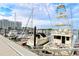 A view of boats docked in a marina, with modern buildings in the background and a clear sky above at 388 Aruba Cir # 201, Bradenton, FL 34209