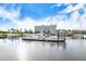 A marina with several sailboats and yachts docked, with a condominium in the background at 388 Aruba Cir # 201, Bradenton, FL 34209