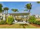 Relaxing park with a shaded seating area, lush landscaping, and views of nearby homes and palm trees at 388 Aruba Cir # 201, Bradenton, FL 34209