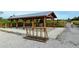 Community park pavilion featuring a picnic table, benches, and bike rack, surrounded by natural landscaping at 388 Aruba Cir # 201, Bradenton, FL 34209