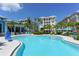 Stunning community pool offers a tranquil escape with palm trees and comfortable lounge chairs at 388 Aruba Cir # 201, Bradenton, FL 34209