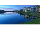 Picturesque water view of townhomes reflecting on a serene lake at sunset, accented by lush greenery and calm waters at 388 Aruba Cir # 201, Bradenton, FL 34209