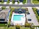 Aerial view of community pool, surrounded by lounge chairs and lush landscaping at 3926 Sunshine Pine Ave, Bradenton, FL 34203