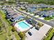 Aerial view of neighborhood and community pool with ample seating, surrounded by lush lawns at 3926 Sunshine Pine Ave, Bradenton, FL 34203
