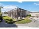 Lovely backyard featuring a screened lanai with a hot tub and manicured lawn at 3926 Sunshine Pine Ave, Bradenton, FL 34203