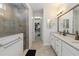 Bright bathroom showcases a glass-enclosed shower, modern vanity, and walk-in closet at 3926 Sunshine Pine Ave, Bradenton, FL 34203
