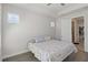 Bedroom with a patterned bedspread, tray ceiling, and light walls at 3926 Sunshine Pine Ave, Bradenton, FL 34203