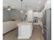 Modern kitchen featuring stainless steel appliances, white cabinetry and a spacious island at 3926 Sunshine Pine Ave, Bradenton, FL 34203