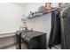 Laundry room is equipped with a modern washer, dryer, and storage shelves at 3926 Sunshine Pine Ave, Bradenton, FL 34203
