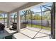 Screened patio with a hot tub and views of the professionally landscaped yard and privacy fence at 3926 Sunshine Pine Ave, Bradenton, FL 34203