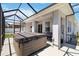 Enclosed patio featuring a hot tub, ceiling fan, and a serene outdoor space at 3926 Sunshine Pine Ave, Bradenton, FL 34203