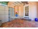 Enclosed back porch features tiled flooring and a table with potted plants at 401 27Th W St, Bradenton, FL 34205