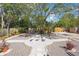 Gravel backyard with a stone patio area and lush landscaping at 401 27Th W St, Bradenton, FL 34205