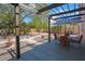 Lush backyard featuring a pergola, dining area, and meticulous landscaping, ideal for outdoor enjoyment and entertaining guests at 401 27Th W St, Bradenton, FL 34205