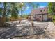 Spacious gravel backyard with a patio, pergola, and mature landscaping at 401 27Th W St, Bradenton, FL 34205