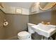 Charming half-bath with bead-board paneling, and a beautiful round mirror at 401 27Th W St, Bradenton, FL 34205