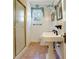 Charming bathroom with pedestal sink, decorative accents, and a shower with gold trim at 401 27Th W St, Bradenton, FL 34205