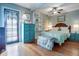 Charming bedroom showcasing wood floors, a ceiling fan, and comfortable furnishings at 401 27Th W St, Bradenton, FL 34205