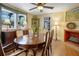 Dining room featuring hardwood floors, a fireplace, and a decorative light fixture at 401 27Th W St, Bradenton, FL 34205