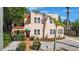 Inviting home showcasing lush landscaping, a tiled roof, and a brick walkway to the front door at 401 27Th W St, Bradenton, FL 34205