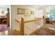 Traditional upstairs hallway with hardwood floors, vintage rugs, and wall decor at 401 27Th W St, Bradenton, FL 34205