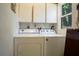 Laundry room with washer, dryer, and storage cabinets at 401 27Th W St, Bradenton, FL 34205