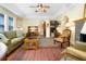 Inviting living room with hardwood floors, ceiling fan, and large windows offering ample natural light at 401 27Th W St, Bradenton, FL 34205