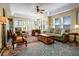 Comfortable living room featuring a fireplace, coffered ceiling, and several windows for natural light at 401 27Th W St, Bradenton, FL 34205