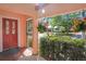 Inviting front porch adorned with hanging flower baskets and wrought iron details at 401 27Th W St, Bradenton, FL 34205