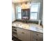 Updated bathroom boasts a granite countertop, modern fixtures, and a bright window at 41 Young Ave, Englewood, FL 34223