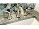 Close-up of bathroom faucet, countertop, and artistic tile backsplash at 41 Young Ave, Englewood, FL 34223