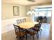 The dining room features elegant lighting, a stylish table, and a view into a bright sunroom at 41 Young Ave, Englewood, FL 34223