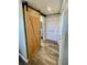 Hallway view showcases a sliding barn door and closet space at 41 Young Ave, Englewood, FL 34223