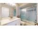 Updated bathroom featuring a white vanity, shower with glass door, and clean tile at 4201 Center Gate Ln # 1, Sarasota, FL 34233