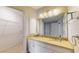 Updated bathroom vanity features granite countertops, mosaic tile backsplash, and white cabinets with modern fixtures at 4201 Center Gate Ln # 1, Sarasota, FL 34233