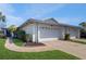 Inviting single-story home featuring a well-maintained lawn, two-car garage, and charming curb appeal at 4201 Center Gate Ln # 1, Sarasota, FL 34233