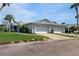 Charming one-story home boasts a manicured lawn, lush tropical landscaping, and a two-car garage at 4201 Center Gate Ln # 1, Sarasota, FL 34233