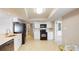 Bright kitchen features white cabinets, black appliances, tile floors, and an adjacent dining area at 4201 Center Gate Ln # 1, Sarasota, FL 34233