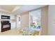 Cozy kitchen nook featuring a sunlit window, black appliances, and a charming breakfast table at 4201 Center Gate Ln # 1, Sarasota, FL 34233