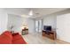 Comfortable living room featuring hardwood style floors, a red sofa, a ceiling fan, and a sliding glass door at 4201 Center Gate Ln # 1, Sarasota, FL 34233