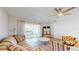 Bright living room featuring wood-look floors, neutral walls, and sliding doors to the outdoor space at 4201 Center Gate Ln # 1, Sarasota, FL 34233